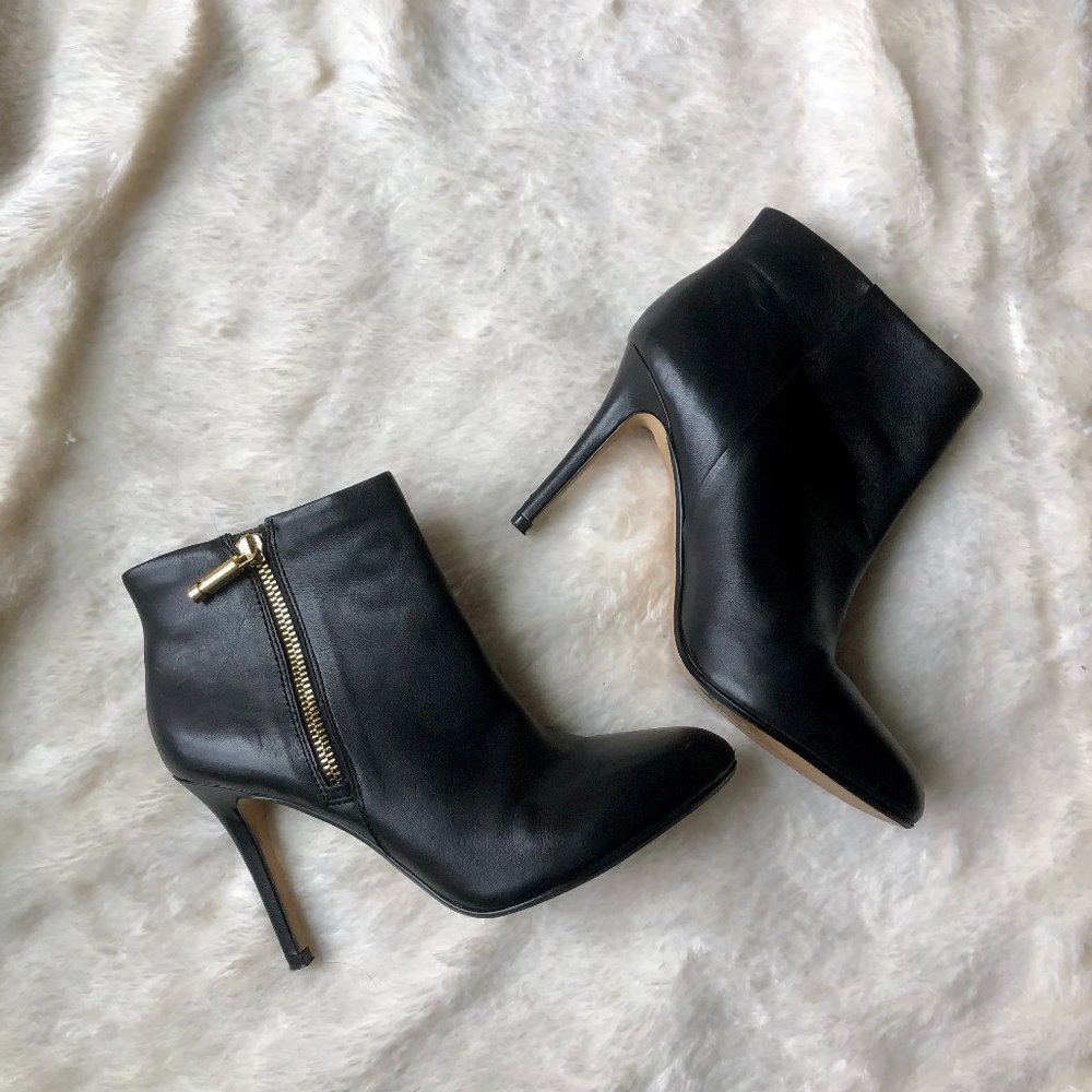 Black leather stiletto ankle booties w/gold zipper